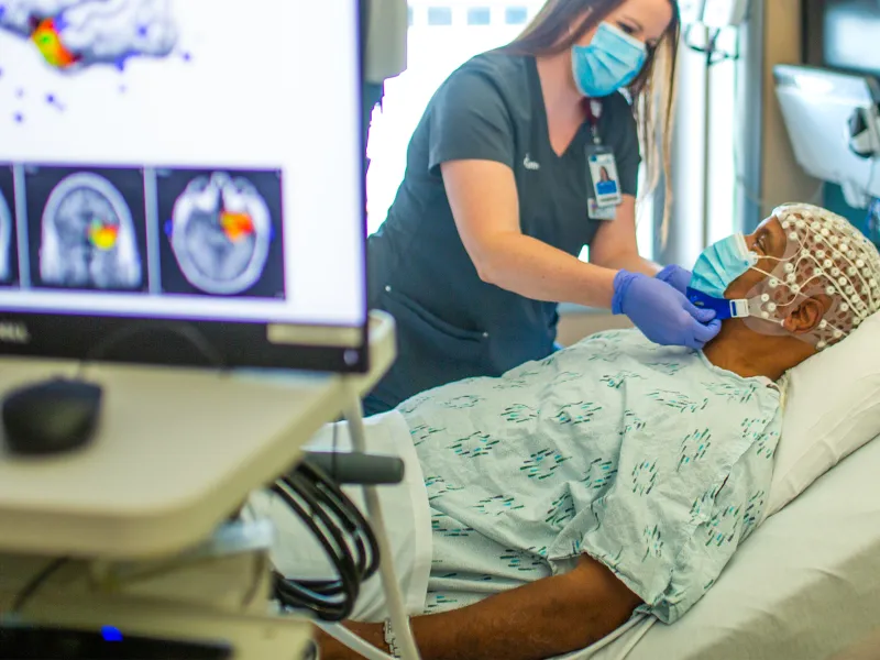 Provider attending patient before brain scan procedure