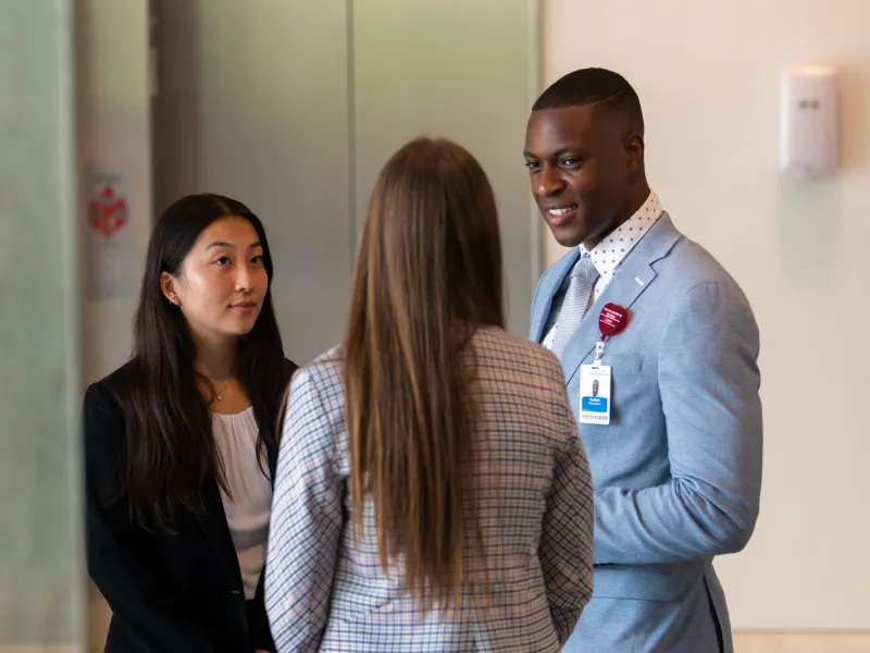 AdventHealth Leadership interns talking in AdventHealth Headquarters lobby.