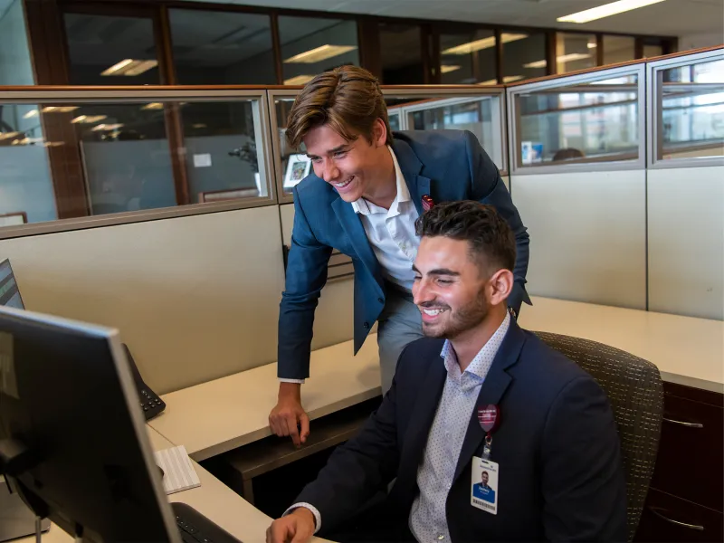 AdventHealth Leadership Interns looking at a computer.