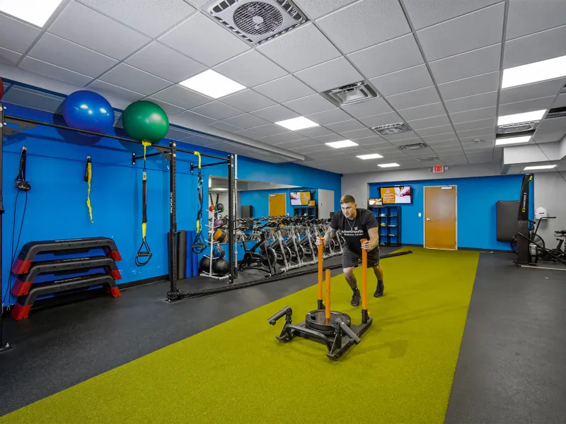 A man working out in the AdventHealth Wellness Center training room