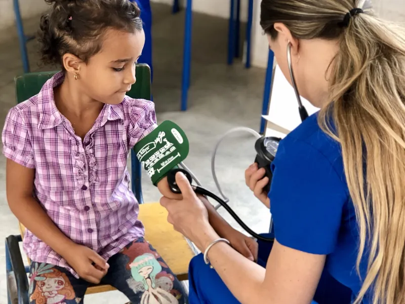 A nurse checking the blood pressure of a girl