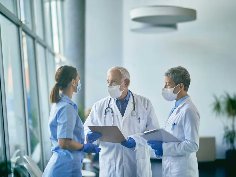 Two doctors and a nurse having a discussion
