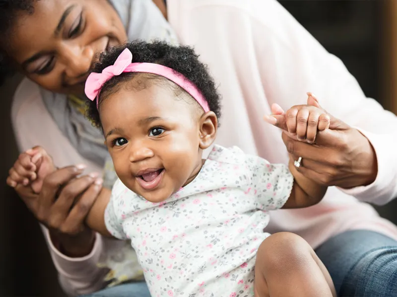 Teaching her little girl to stand.