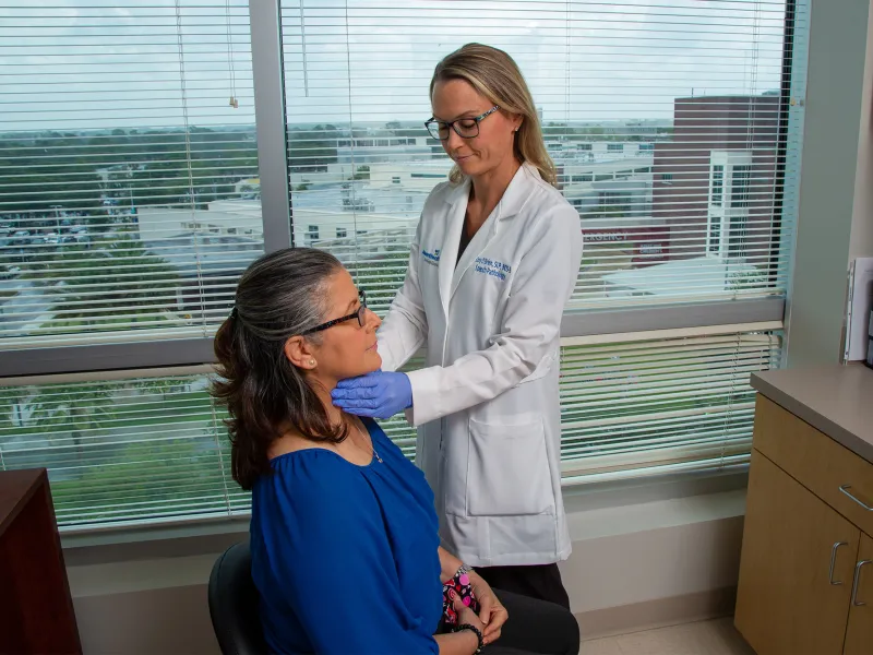 Doctor Cory O'Brien examining patient's throat.