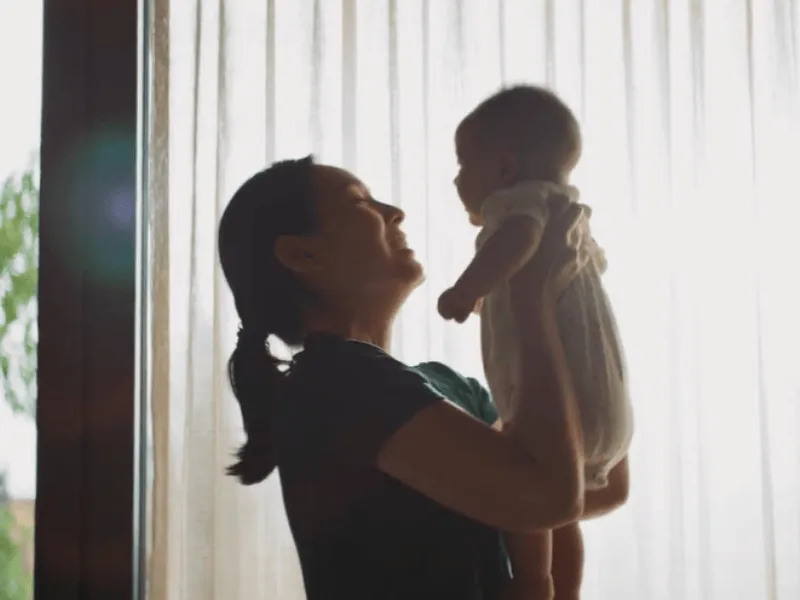 mother holding baby
