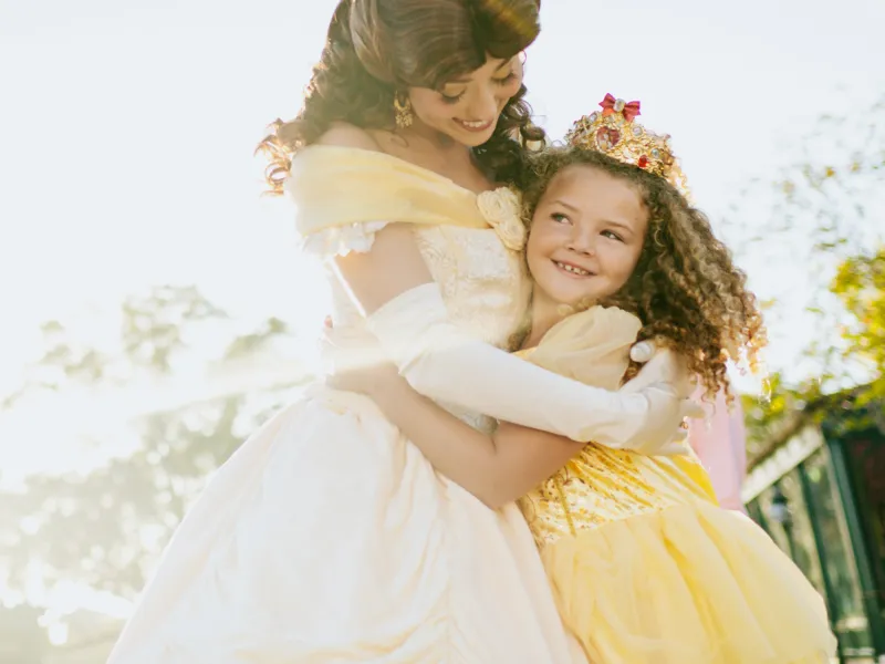A Child at Walt Disney World Hugs the Disney Princess Belle
