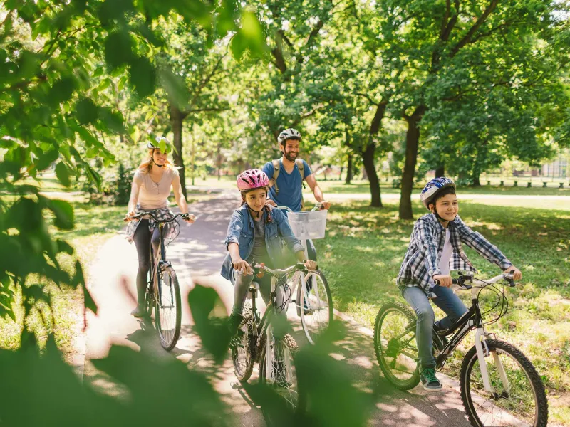 A family on a bike ride at a park