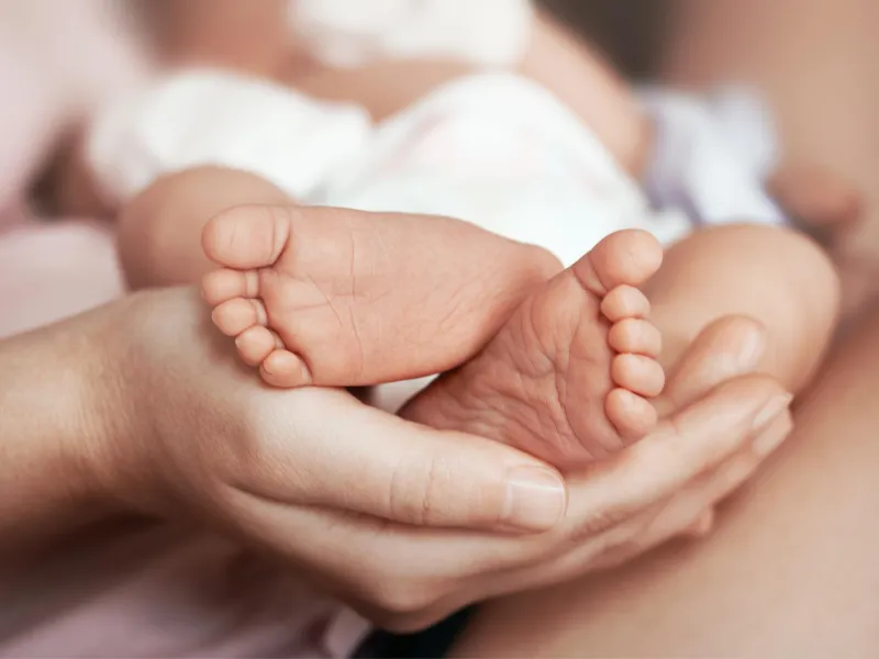 Mother holding her baby's feet