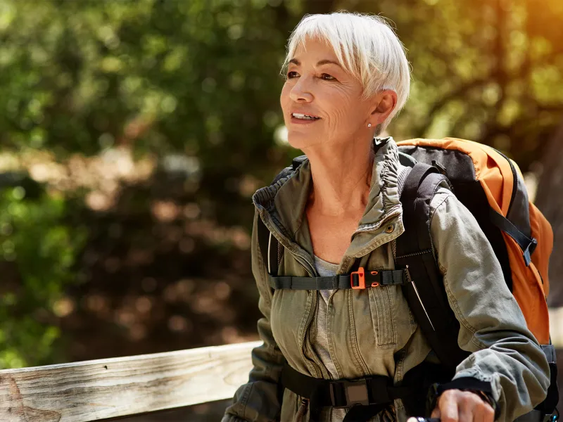 Older female backpacker out for a hike