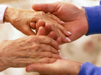 Two people hold hands.