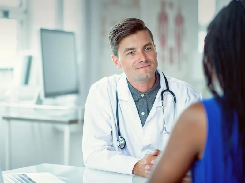 Doctor sitting at a table with a patient