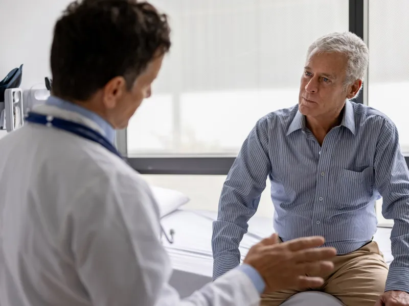 A Doctor Speaks to His Senior Patient About His Treatment Plan in an Exam Room