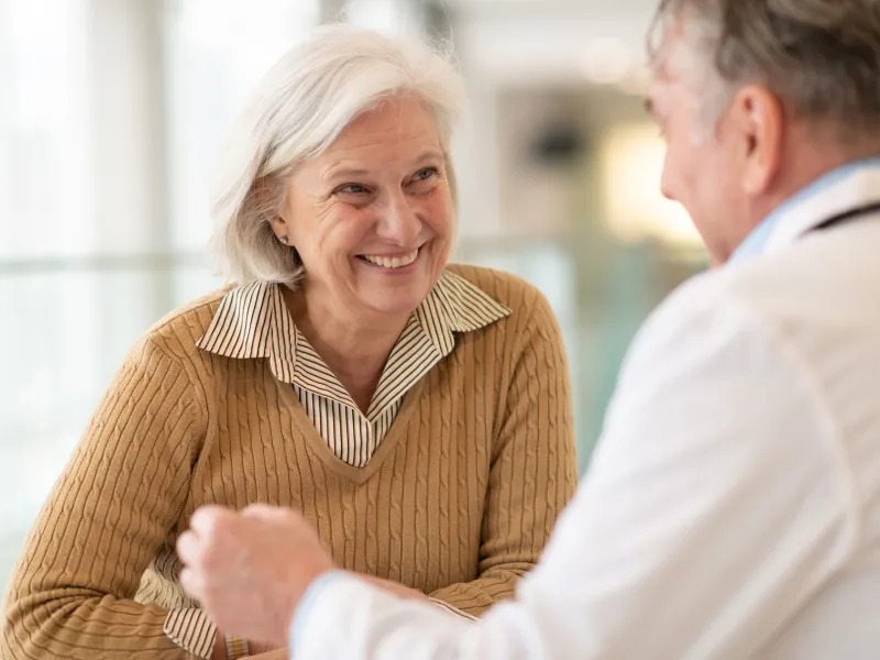 A woman discusses her health with her doctor.