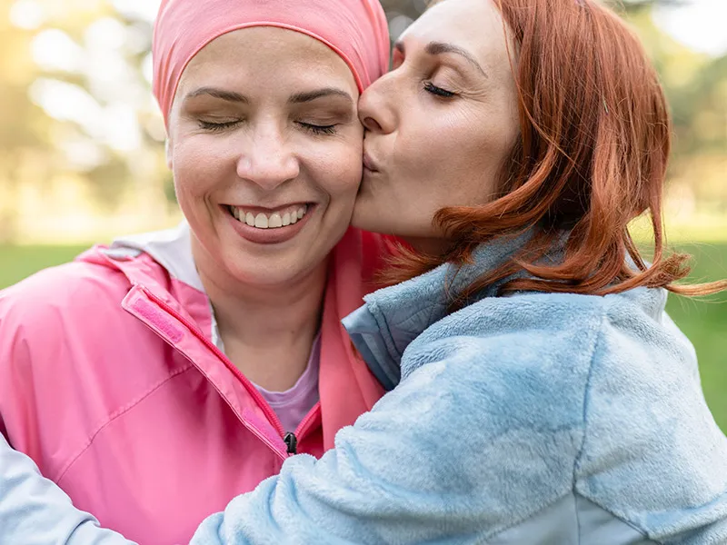 daughter kissing and hugging her mother