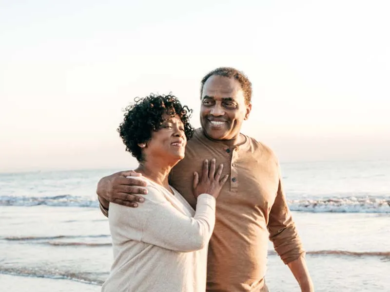 Middle-aged couple walking on beach
