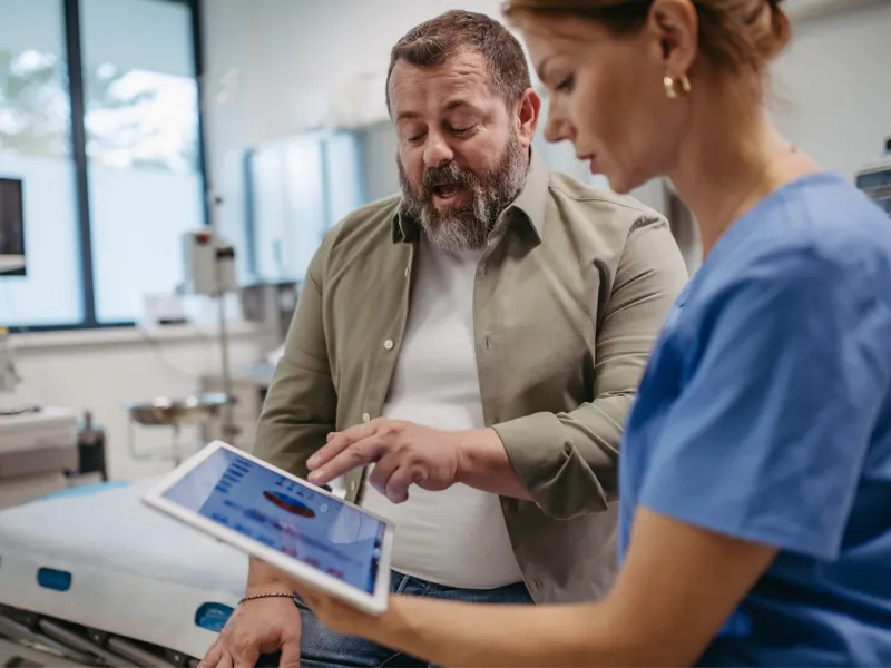 A male patient talks with a female doctor about his test results.