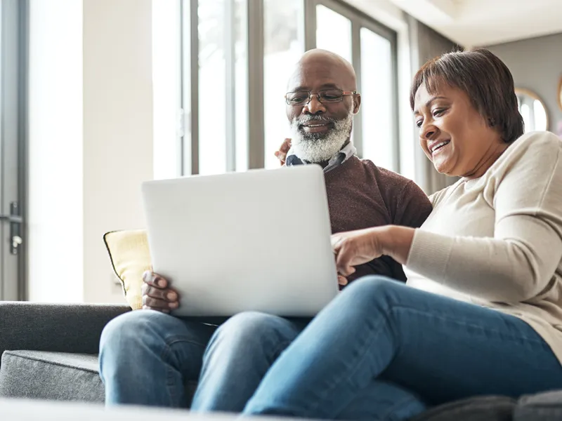 a man and a woman on a laptop 