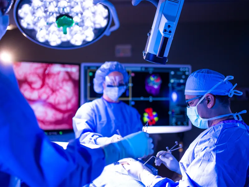 Neurosurgeon team in an operating room performing a surgery.