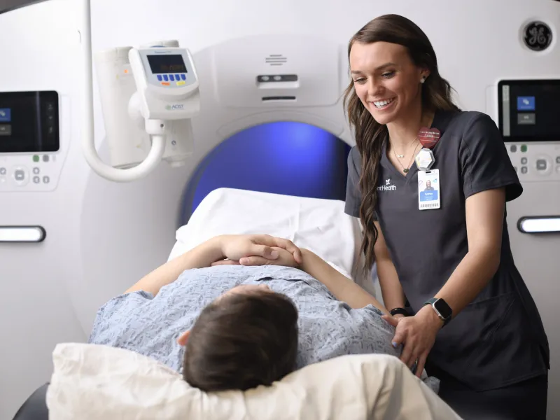 Radiologist reassures patient before imaging procedure.