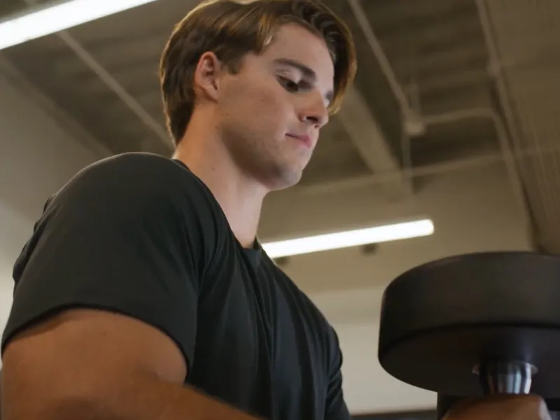 A young man lifting weights