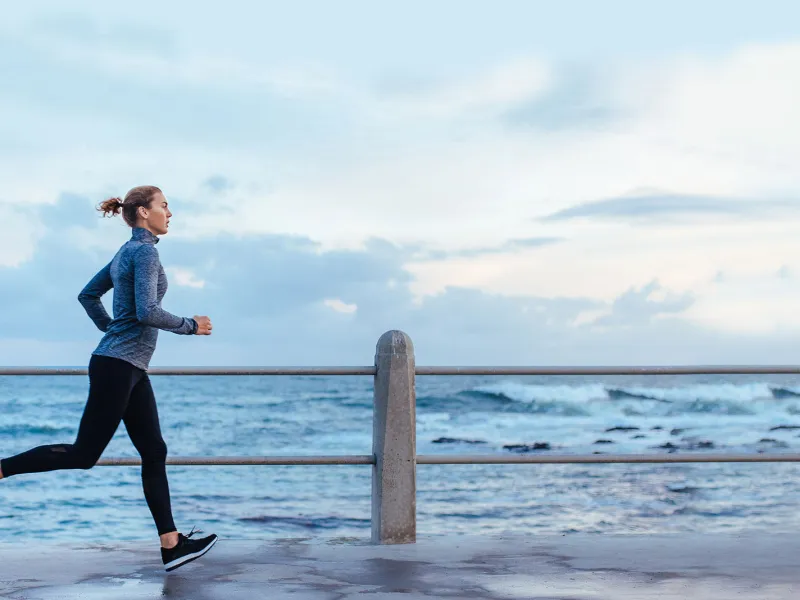 Woman running along the beach
