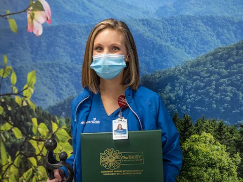 cassie ferguson holds award