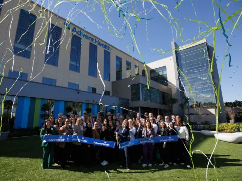 Team members cut the ribbon to officially open AdventHealth Minneola.