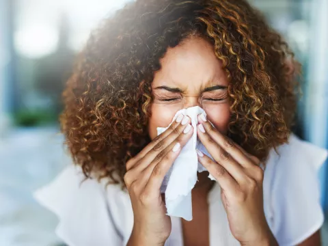 A Woman Blows Her Nose