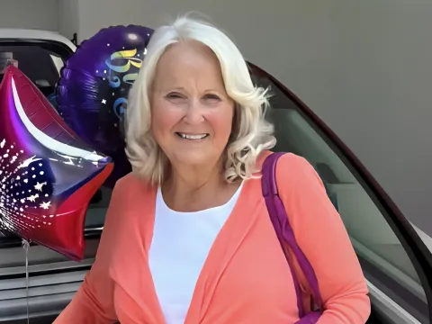 Peggy posing with balloons.
