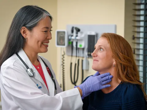 Physician examining patient's throat