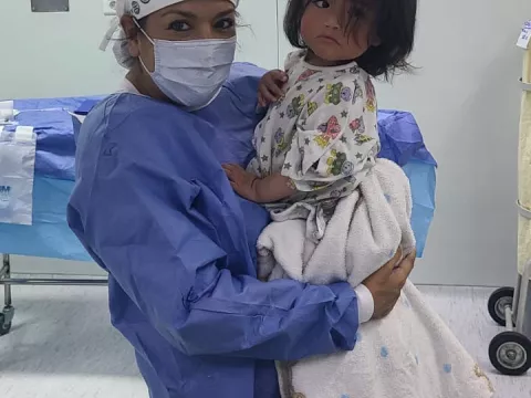 Maria Rodammer holding a child