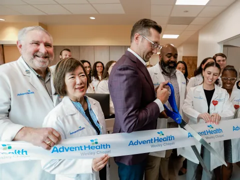 Group of people at the ribbon cutting of Wesley Chapel.
