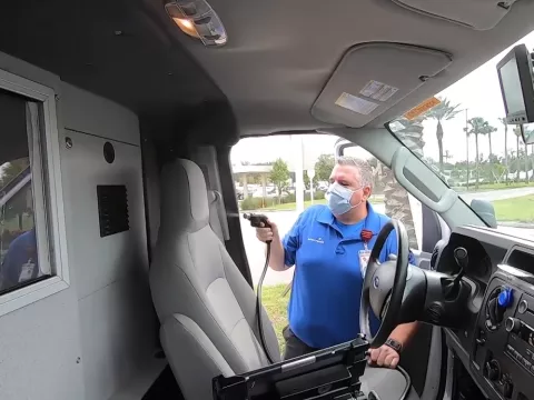 Team member decontaminates an ambulance using Aeroclave