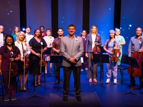 Director saw orchestra as the perfect way to bring team members together during a dark time.