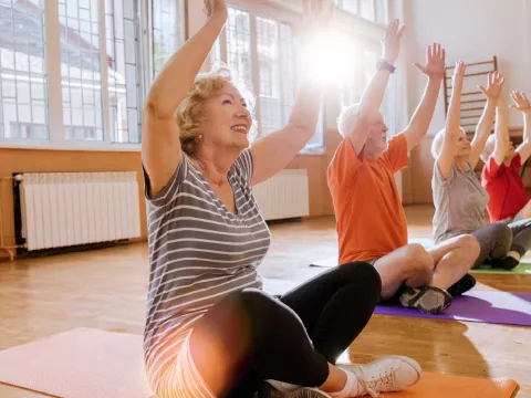 A group of seniors doing a yoga session