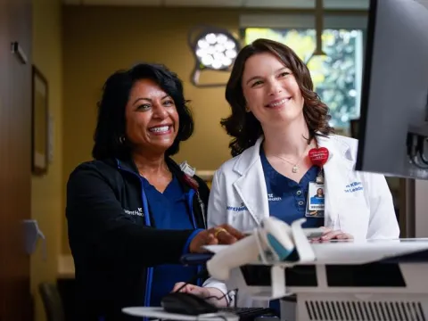 Nurse and doctor at a computer monitor