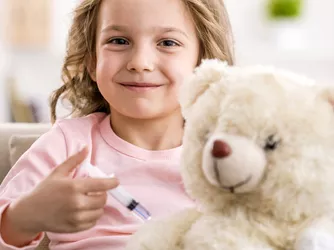 child smiling while posing for a shot