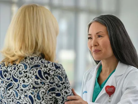 Female AdventHealth doctor speaking with a woman