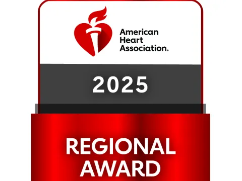 A grey, red and white badge that reads: American Heart Association Regional Award - Mission: Lifeline