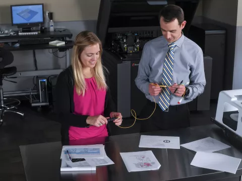 Two professionals working in the Nicholson Center prototype lab.