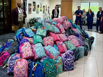 Chaplain Derrick Hough blessing the backpacks