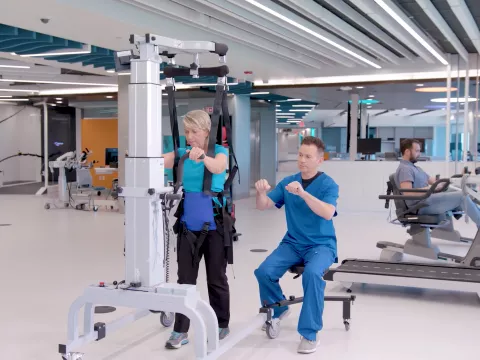 A Therapist Helps a Patient Through a Physical Therapy Session.