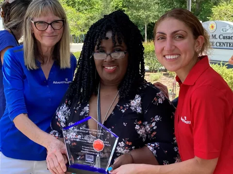 Community Benefit team, Debi McNabb and Ida Babazadeh pose with Shilretha Dixon from the City of DeLand.