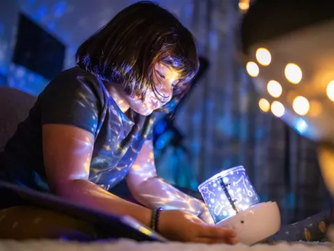 Child holding light projector