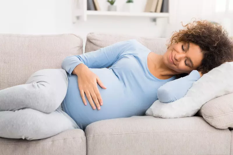 A pregnant woman resting at home.