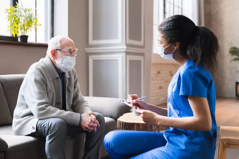 A Patient Speaks with a Provider in the Lobby of a Medical Practice. 