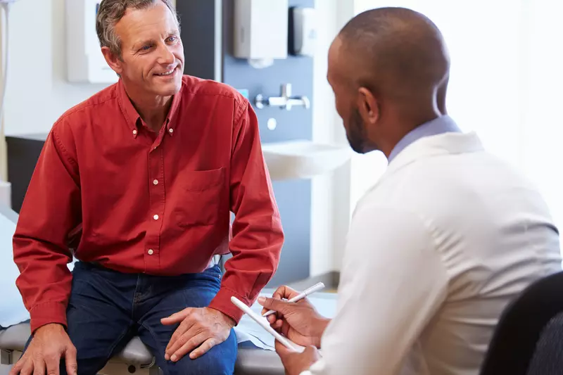 A man discusses his health with his doctor.
