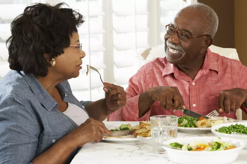 This caregiver eats a diabetic-friendly meal with their loved one.