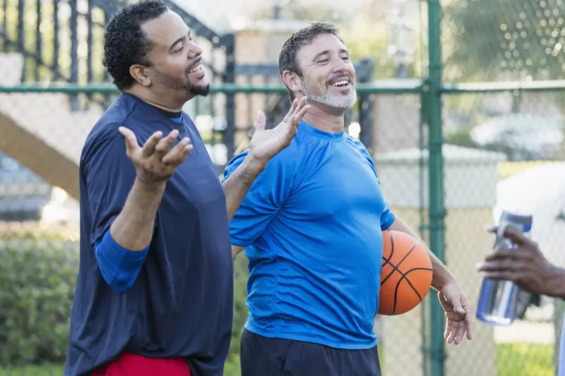 Group of men staying healthy playing basketball