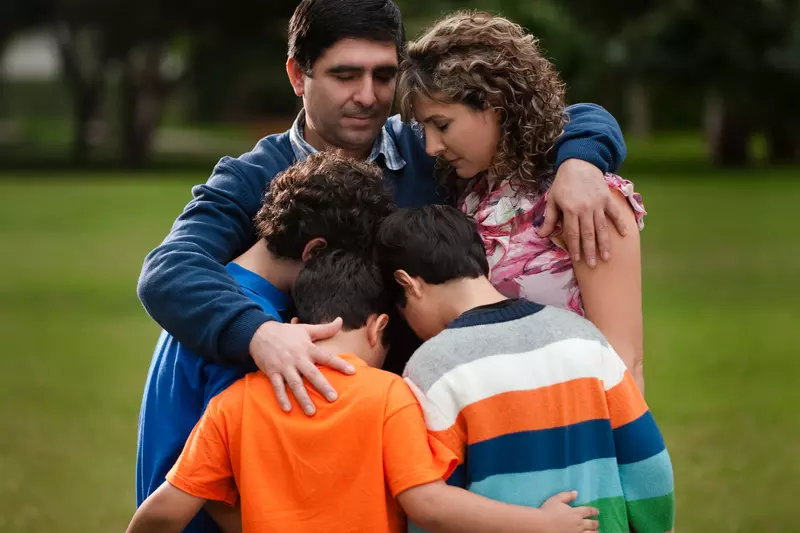 A family hugs and counts their blessings.